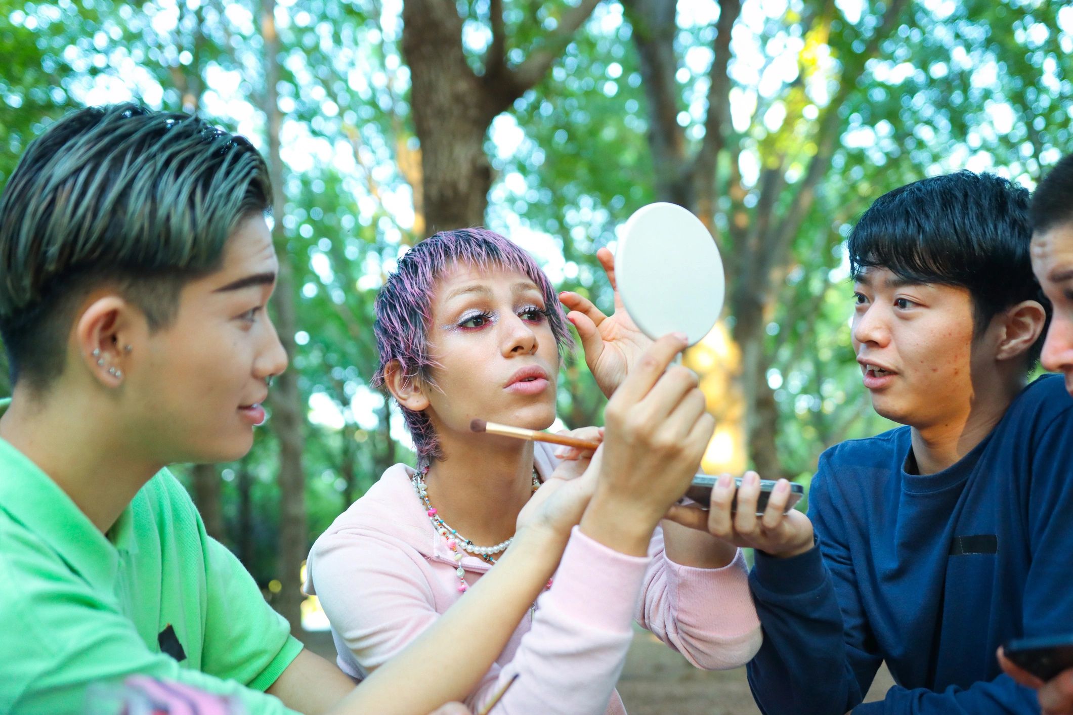 Customer applying makeup outdoors