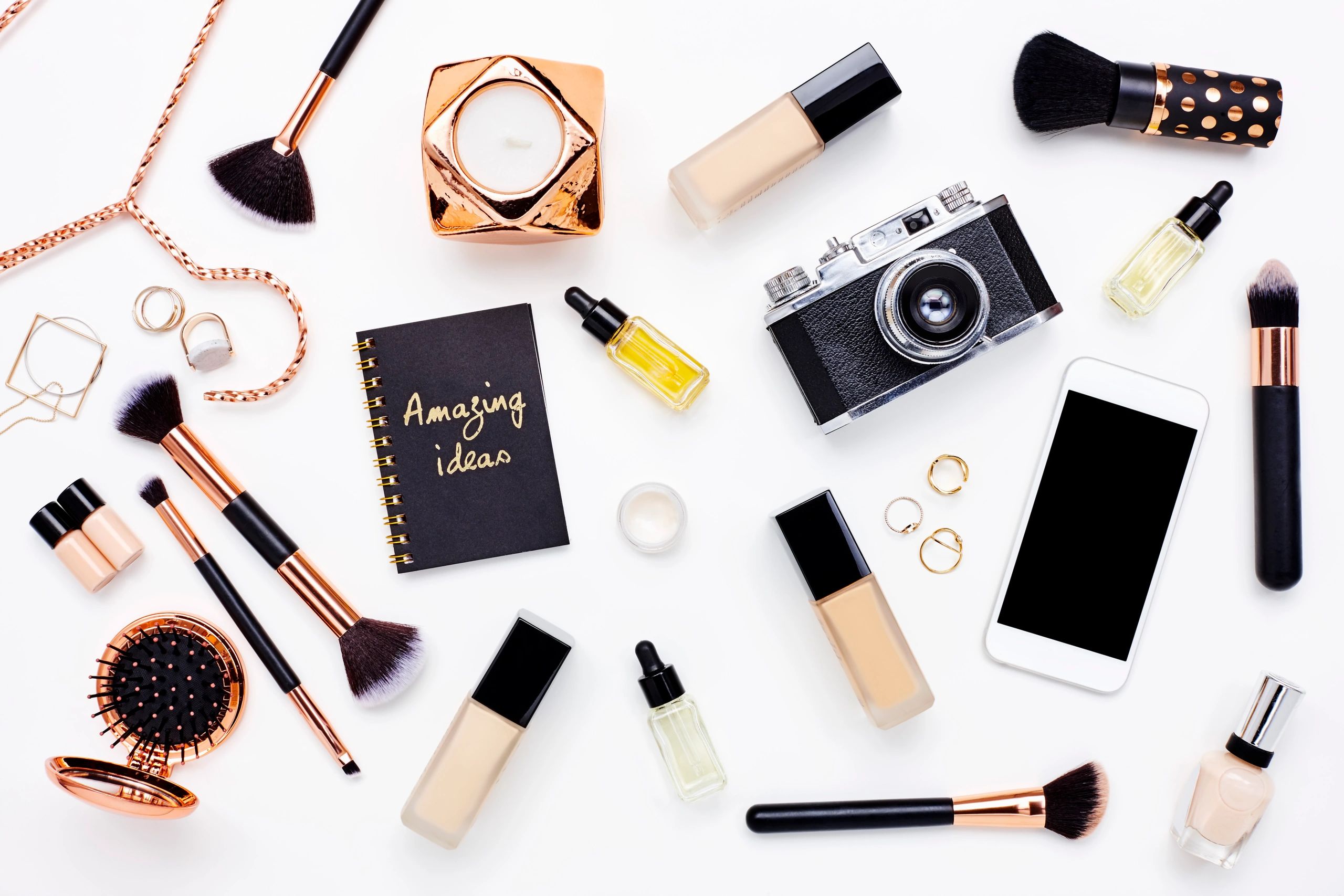 Flat lay of beauty products and accessories on a clean white background